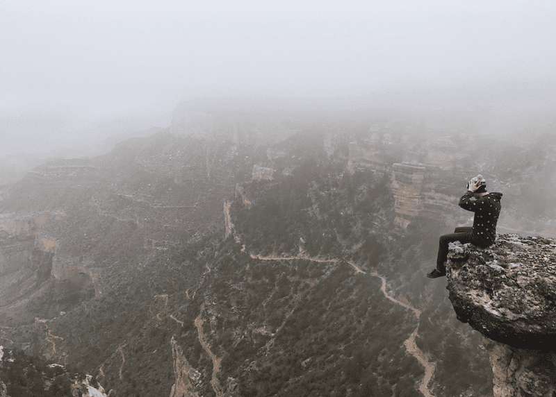 A hiker looking out over an immense vista, demonstrating what business feels like.