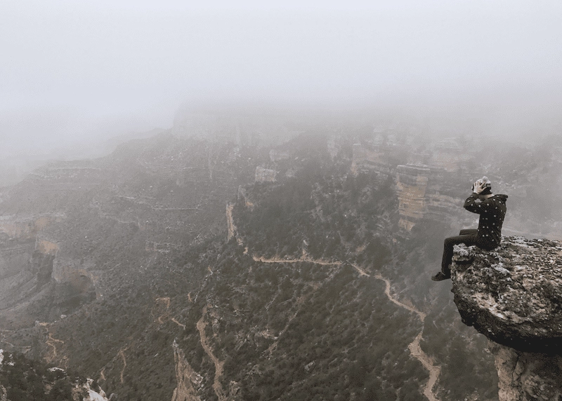 A hiker looking out over an immense vista, demonstrating what business feels like.