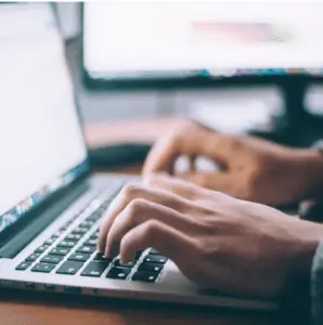 Hands typing on a keyboard